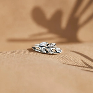 Close-up of vintage leaf-shaped ring with marquise-cut zircon stones and silver finish