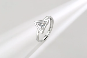 Detailed close-up of a silver triangle zircon ring featuring a geometric open design