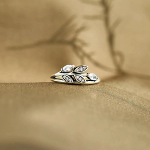 Macro shot of silver vintage leaf ring featuring marquise-cut and pavé-set zircons