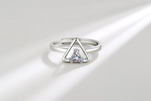 Macro shot of silver open adjustable ring featuring a geometric triangle zircon stone
