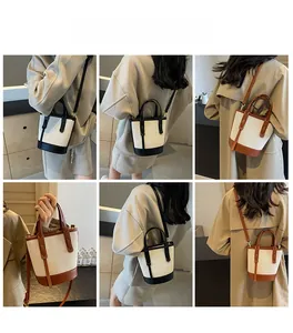 Detail view of canvas bucket bag with leather trim shown in various carrying styles