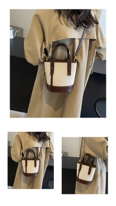 Detail of canvas bucket bag with brown leather trim and adjustable crossbody strap