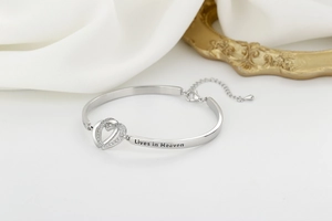 Detail of silver heart bracelet with sparkling zircon and 'Lives in Heaven' engraving