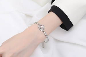 Detail of silver heart bracelet with sparkling zircon pavé and engraved sentiment