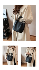 Close-up of black vertical pleated texture bag with silver metal hardware details