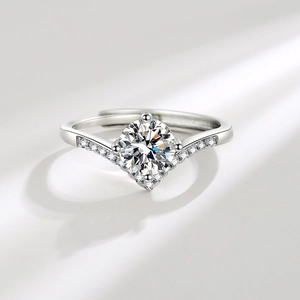 Polished silver V-shaped crown ring with a sparkling moissanite stone and adjustable band