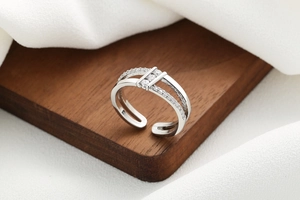 Detail of silver double-layered open ring featuring pavé zircons and a polished finish