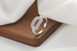 Detail of silver interlocking oval rings with micro-pave cubic zirconia crystals
