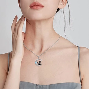 Moon and black cat pendant necklace with moonstone on a silver chain worn by a model