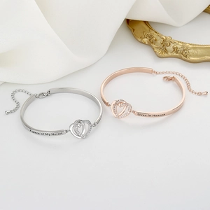 Double heart interlocking bracelets in silver and rose gold with engraved inscriptions