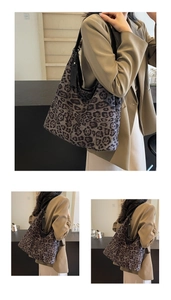 Detail of a large leopard print tote bag with black leather shoulder straps on a model