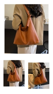 Detail view of large brown faux leather tote bag with lychee texture and shoulder strap