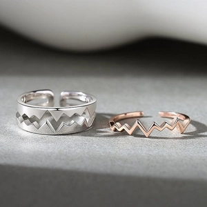 Minimalist heartbeat couple rings set featuring silver and rose gold mountain geometry