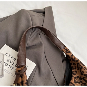 Close-up of leopard print tote bag with premium lychee grain leather shoulder strap