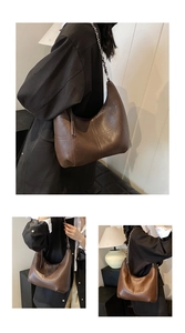 Detail view of dark brown PU leather Hobo bag with cross stitching and chain strap