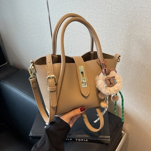 Classic camel litchi grain leather tote bag with gold buckle and plush lion charm