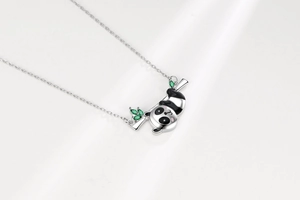 Detailed macro view of silver panda necklace with green zircon bamboo and black oil drip finish