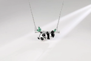 Detail of panda pendant with green zircon bamboo and black enamel finish on S925 silver
