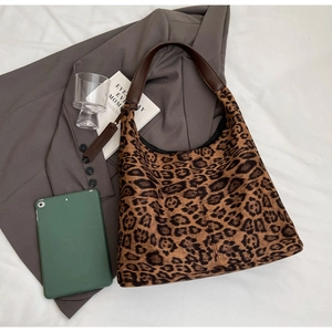Detail of leopard print tote bag with faux fur texture and dark brown leather straps