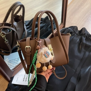 Brown lychee leather bucket handbag with gold twist lock and cute sheep charm ornament