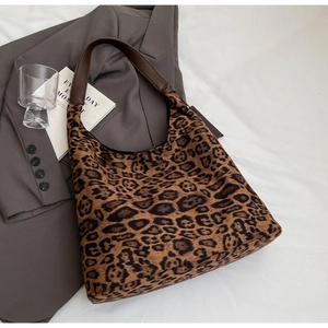 Close-up of leopard print tote bag with brown PU leather strap on a white background