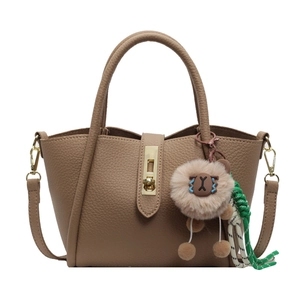 Chic khaki lychee leather bucket bag with golden lock and plush lion charm detail