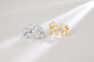 Detail of silver and gold leaf rings with iridescent mother of pearl shell inlay