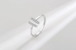 Detail of minimalist double-row pavé diamond open ring in a modern silver finish