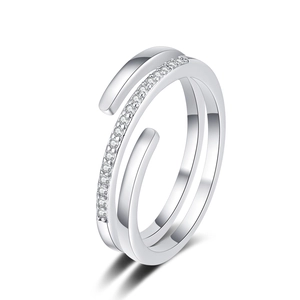 Macro detail of silver layered open ring featuring a band set with shimmering zircons