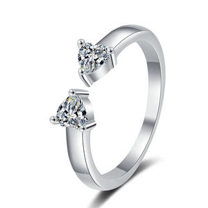 Detail of silver open ring featuring double heart-shaped cubic zirconia in a macro view