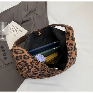 Top view of leopard print tote bag interior showing large capacity with personal items