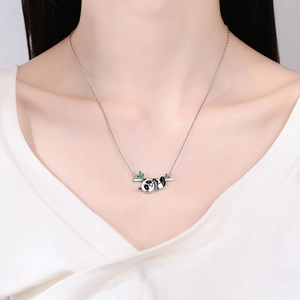 Cute panda pendant necklace with bamboo leaf worn on neck for a minimalist jewelry look