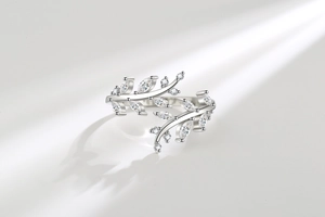 Detailed macro view of olive branch leaf ring with marquise and round zircon stones