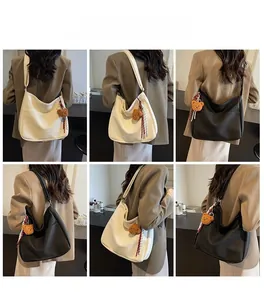 Detailed model views of large litchi leather tote bag in white and black finishes