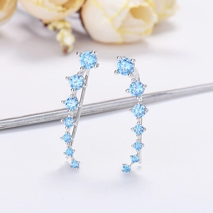 Elegant silver ear crawlers with seven gradient light blue zircons in a curved layout