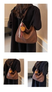 Close-up of brown faux leather hobo bag with teddy bear pendant and woven rope detail