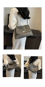 Detail of grey matte large tote with metal chain strap and rectangular logo plaque