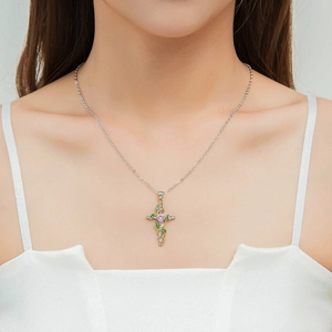 Elegant cross necklace with green leaves and pink gem pendant on a silver-plated chain