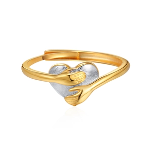 Two-tone hugging hands heart ring in gold and silver finish with adjustable band