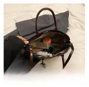 Interior view of the dark brown tote bag showing its spacious capacity for cosmetics