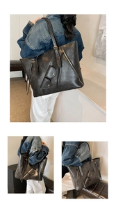 Detail of vintage tote bag with decorative zippers and soft matte faux leather texture