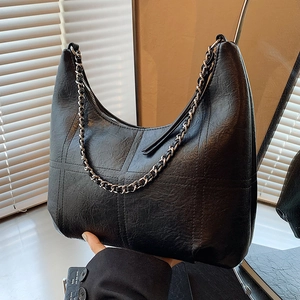 Vintage black wrinkled leather tote bag with stylish metal chain and shoulder strap