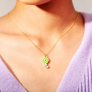 Bohemian gold chain necklace with green hexagonal evil eye pendant and crystal accents