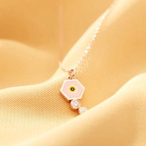Rose gold hexagonal necklace featuring a pink enamel evil eye charm with zircon accents