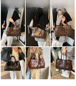 Multi-angle view of brown and black tote bags with metal clasp and tassel detail