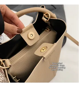 Detail view of beige lychee leather bucket bag with magnetic closure and inner zipper pocket