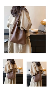 Detail of brown lychee grain leather tote bag with gold metal buckle and double pockets