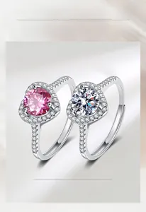 Detail of pink and white heart halo rings with pave set diamonds on a 925 silver band