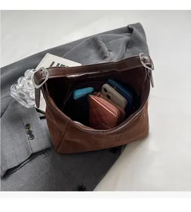 Hobo bag interior view showing large capacity for phones and a long wallet