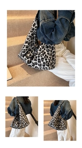 Detailed close-up of a large leopard print tote bag with soft fabric and black straps